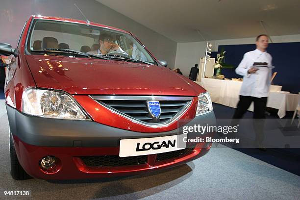 Visitor sits in a Renault-Dacia X90 in Guyancourt, near Paris, France, Wednesday, June 2, 2004. France's second-largest carmaker, unveiled a...