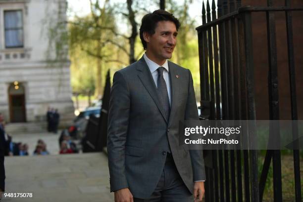 Canadian Prime Minister Justin Trudeau smiles as he arrives Downing Street to meeting British Prime Minister Theresa May for talks on April 18, 2018...