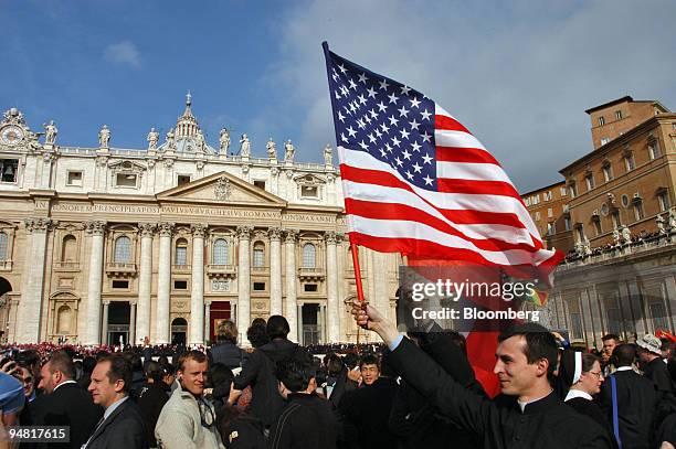 Father John Kulig, a Polish priest attending the funeral service of Pope John Paul II, waves an American flag in St. Peter's Square Friday, April 8,...