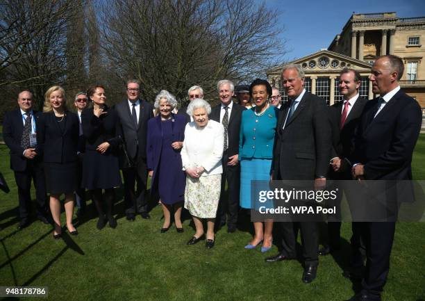 Queen Elizabeth II is accompanied by Baroness Scotland, Secretary General of the Commonwealth , Hugo Vickers and guests during the unveiling of a...