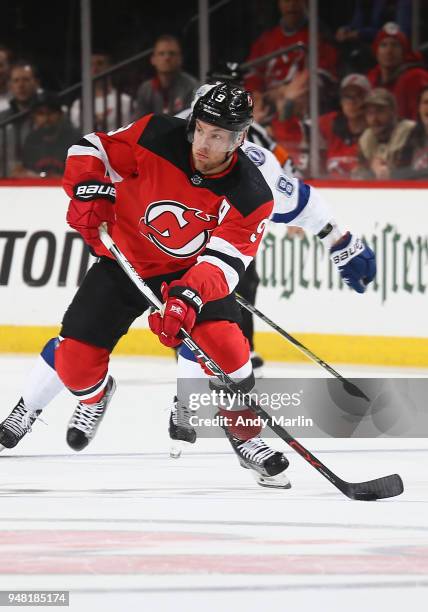 Taylor Hall of the New Jersey Devils plays the puck in Game Three of the Eastern Conference First Round against the Tampa Bay Lightning during the...