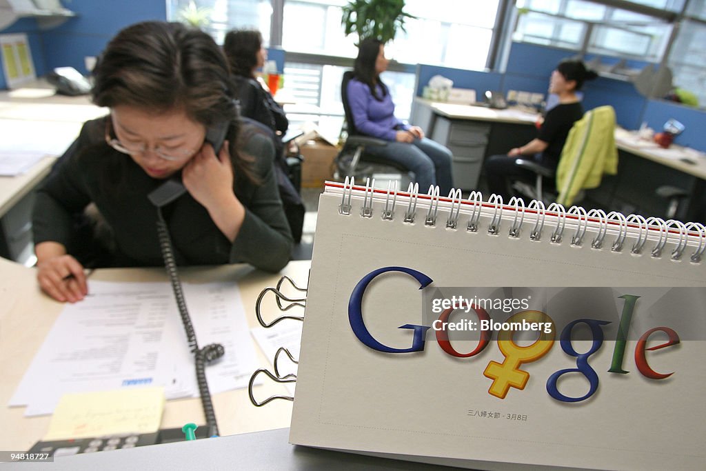 Google employees work by a calendar that features the compan