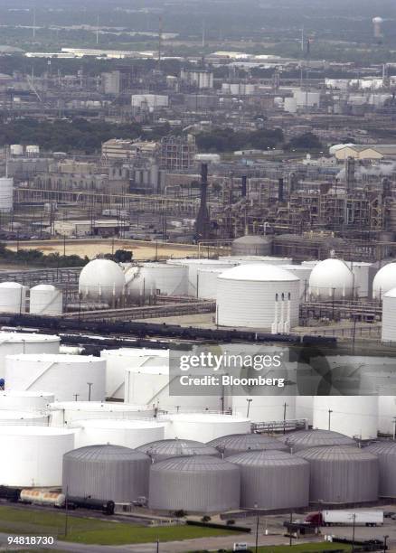 Storage tanks at oil refineries are seen along the Houston Ship Channel in Houston, Texas, Wednesday, June 9, 2004. Crude oil futures fell to the...