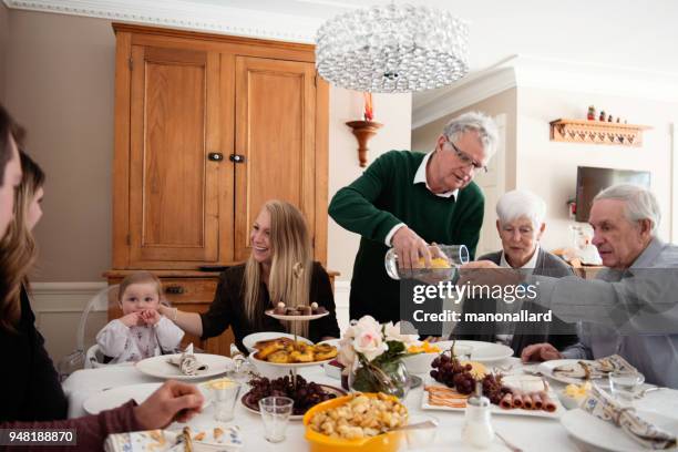 big family dinner including mult-generation family like senior and millennial family. - big family dinner stock pictures, royalty-free photos & images