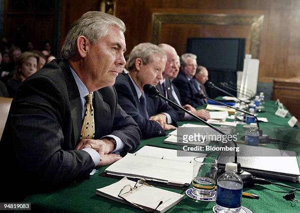 Rex Tillerson, chairman, president and chief executive officer of ExxonMobil Corp., left, listen during a hearing of the Senate Judiciary Committee...