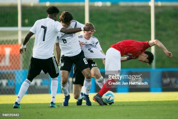 Charles-Jesaja Herrmann, Elias Abouchabaka of Germany, Niclas Stierlin of Germany and Vesel Demaku of Austria fight for the ball during the...