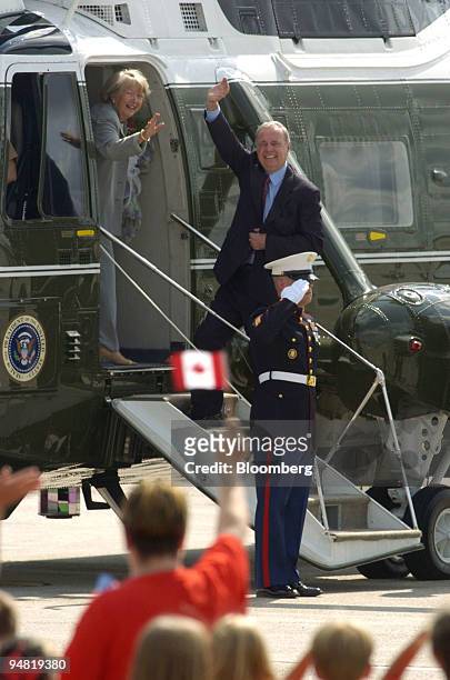 Canadian Prime Minister Paul Martin and his wife Sheila wave to the crowd as they board a U.S. Marine helicopter upon their arrival to Hunter Army...