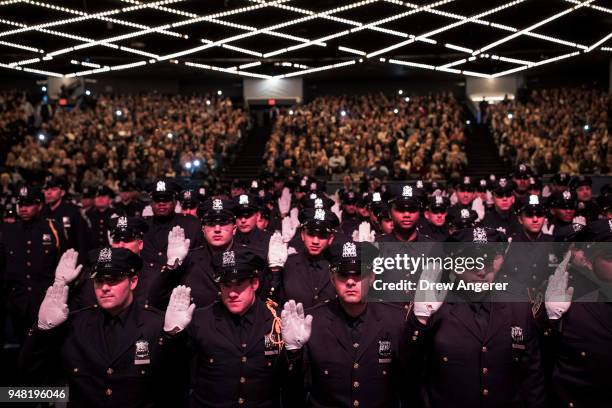 The newest members of the New York City Police Department are sworn-in during their police academy graduation ceremony at the Theater at Madison...