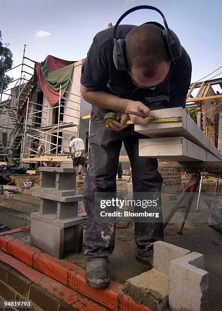 Builders work on the site of a new house in Sydney, Australia March 31, 2005. Australia's home-loan approvals rose by the most in eight months to a...