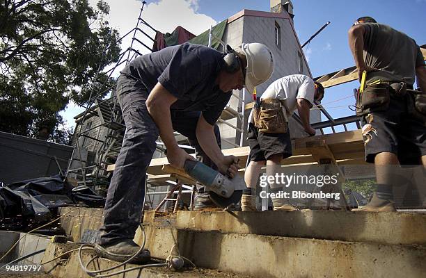 Builders work on the site of a new house in Sydney, Australia March 31, 2005. Australia's home-loan approvals rose by the most in eight months to a...