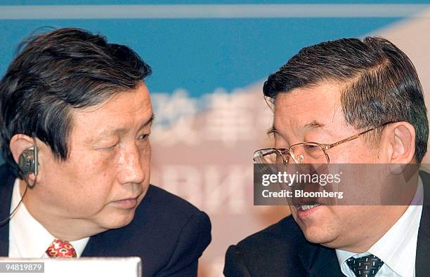 Chairman of the National Development Reform Commission Ma Kai, left, listens to China National Petroleum Corporation General Director Chen Geng at...