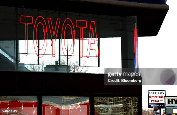 Neon sign on display in the window of a Toyota dealer with Buick, Pontiac, GMC sign, right, in Little Falls, New Jersey, Wednesday, March 16, 2005....