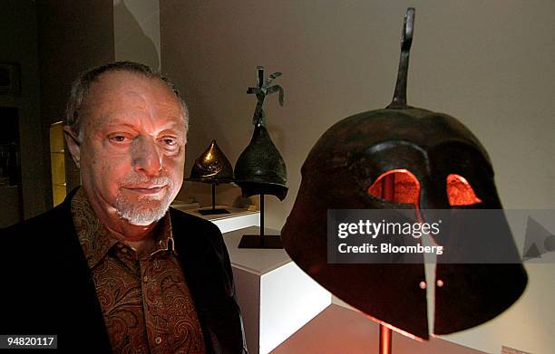 Antiquities dealer Jerome Eisenberg is pictured with a selection from his stock of ancient military helmets in Brussels, Belgium on Saturday, June...