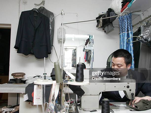 Tailor Cong Youxin makes a woolen suit in Beijing, China, on January 16, 2005. Wool growers in Australia are enlisting movie star Yin Xiaotian to...