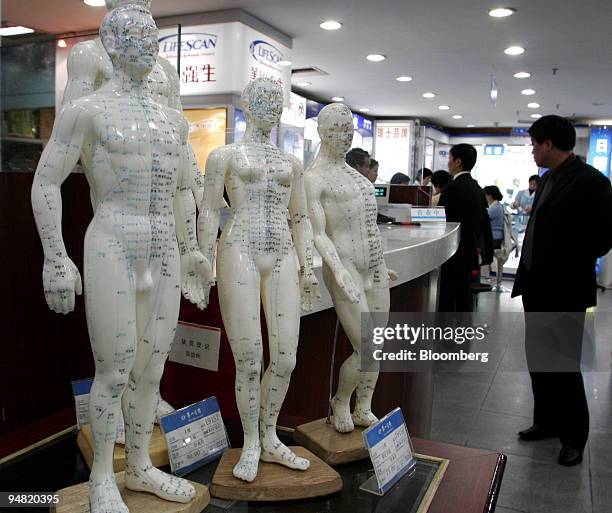 Figurines showing acupuncture points seen in a pharmacy in Shanghai, China, Tuesday, March 21, 2006. Overseas insurers, including AIG and Manulife...