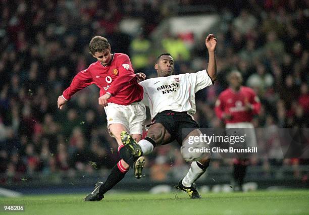 Ole Gunnar Solskjaer of Manchester United gets his shot in before Fabian Wilnis of Ipswich Town can make a challenge during the FA Carling...