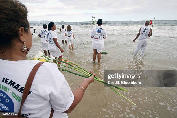 Devotees of the afro-Brazilian sea-goddess Yemonja make offerings to the sea on Copacabana beach in Rio de Janeiro, Brazil, December 29, 2005. These...