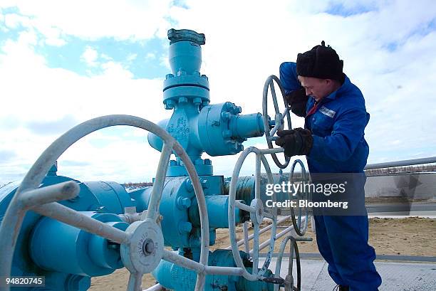 Worker checks a gas valve at one of the OAO Gazprom refineries in Urengoy, Siberia, Russia, Thursday, June 3, 2004. Russia's state-owned OAO Gazprom,...