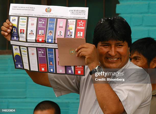 Bolivian Presidential candidate Evo Morales, of the Movement Towards Socialism party , holds up his ballot before casting his vote in Chapare,...