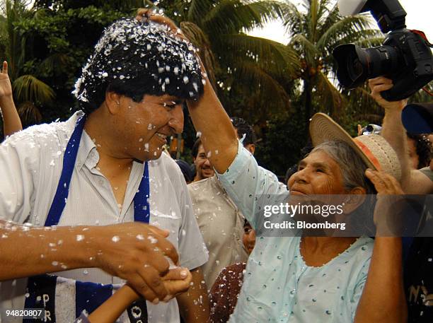 Bolivian Presidential candidate Evo Morales, of the Movement Towards Socialism party , receives a blessing from a woman upon his arrival to cast his...
