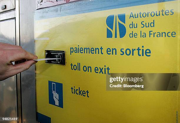 Customer uses a tollboth belonging to the Autoroutes du Sud de la France in Arveyres, near Bordeaux, France, Monday, January 16, 2006.