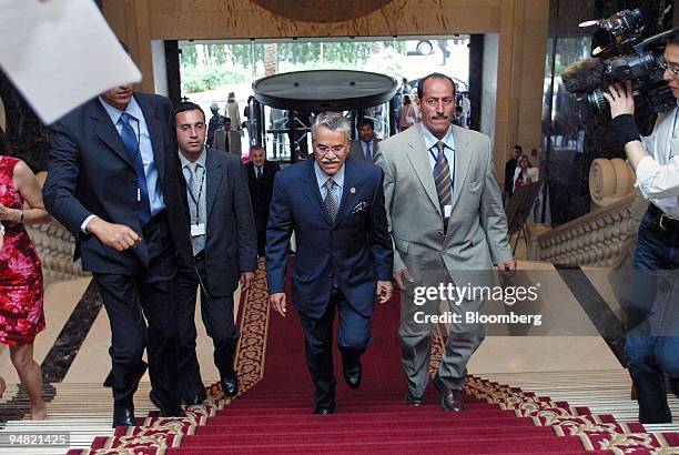 Saudi Oil Minister Ali al-Naimi, center,arrives with security men in the lobby of the Phoenicia Intercontinental in Beirut, Wednesday, June 2, 2004....