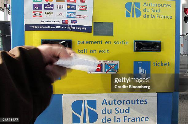 Customer uses a tollboth belonging to the Autoroutes du Sud de la France in Arveyres, near Bordeaux, France, Monday, January 16, 2006.