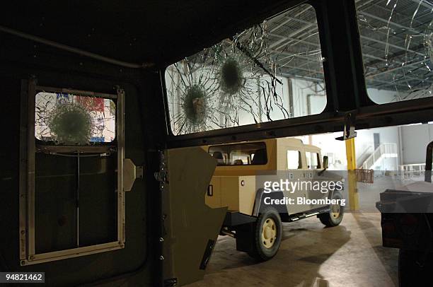 The windows in a bullet-proof modular armor kit, made for military version of the HumVee vehicle, are shown after they stopped rounds test-fired from...