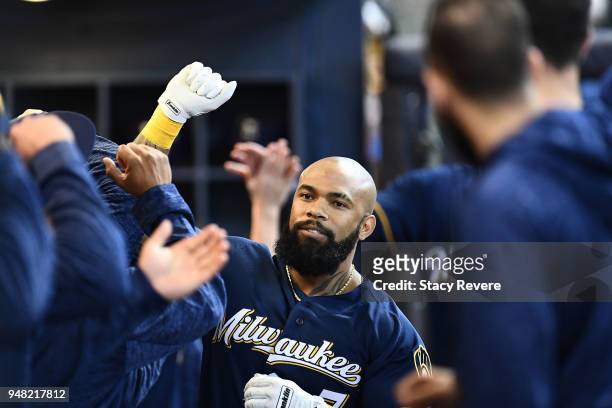 Eric Thames of the Milwaukee Brewers is congratulated by teammates after a two-run home run against the Cincinnati Reds during the third inning at...