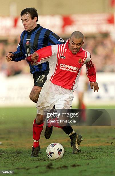 Junior McDougald of Dagenham and Redbridge is watched by Steve Brown of Charlton Athletic during the FA Cup Third Round Replay at the Victoria Ground...