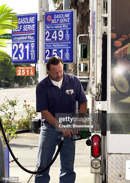 Joe Van Dieren pumps diesel gasoline, priced at $2.51.9, into his truck Monday morning, March 21, 2005 at Bob's 76 Service station in Fullerton,...