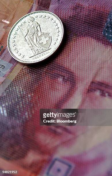 Swiss currency is seen arranged in Bern, Switzerland, Friday, March 17, 2006. Citigroup Inc. Cut its forecasts for the yen and Swiss franc because...