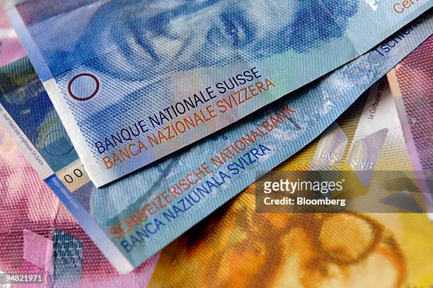 Swiss currency is seen arranged in Bern, Switzerland, Friday, March 17, 2006. Citigroup Inc. Cut its forecasts for the yen and Swiss franc because...