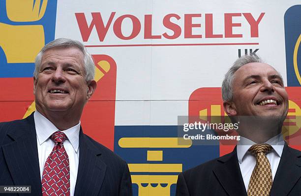 Charlie Banks, Wolseley chief executive, left, and finance chief Steve Webster pose against a Wolseley truck in London, Monday, March 21, 2005....