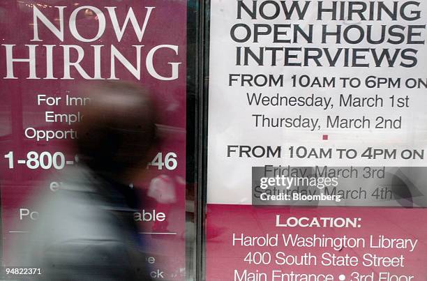 Woman walks by a sign in a window where an Annie sez store is scheduled to open on State Street in Chicago, Illinois. American employers added a...