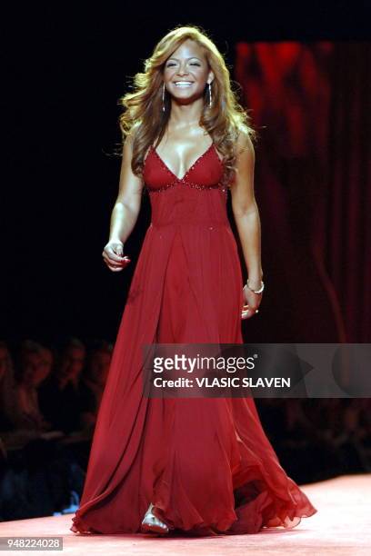 New York, NY - FEB. 3, 2006: Singer Christina Milian walks the runway at the Heart Truth's Red Dress show during the Fall/Winter 2006 Olympus Fashion...