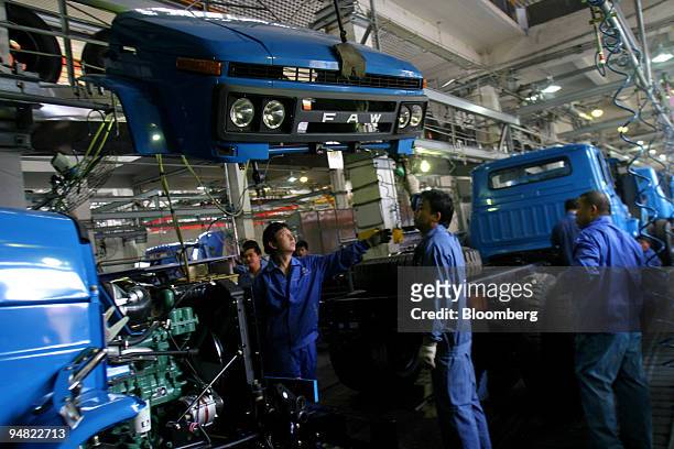Production line workers assemble a 'Jie Fang' model truck at the China First Auto Works plant in Changchun, China May 25, 2004. China FAW Group...