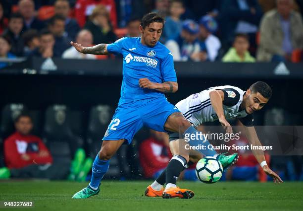 Andreas Pereira of Valencia competes for the ball with Damian Suarez of Getafe during the La Liga match between Valencia and Getafe at Mestalla...