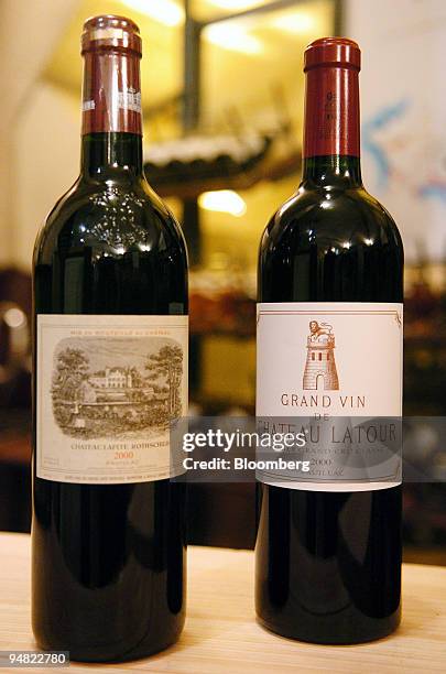 Bottle of a Chateau Lafite, left, and a bottle Chateau Latour, right, are displayed in a wine shop in Paris, France, Wednesday, March 15, 2006. A...