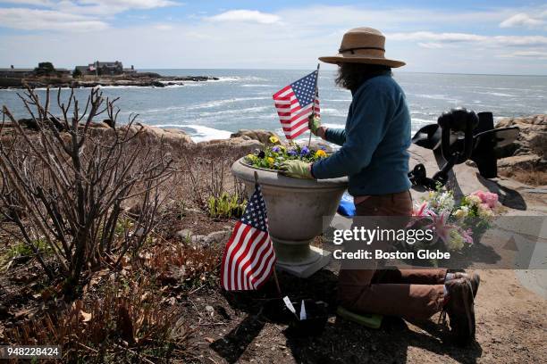 Elizabeth Spahr of the Kennebunkport Conservation Trust plants flowers honoring Barbara Bush near the family's home at Walker's Point in...
