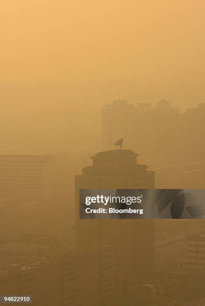 The Guomao neighborhood stands in the midst of pollution seen in the late afternoon in Beijing, China, on Jan. 10, 2006. Beijing is facing a mounting...