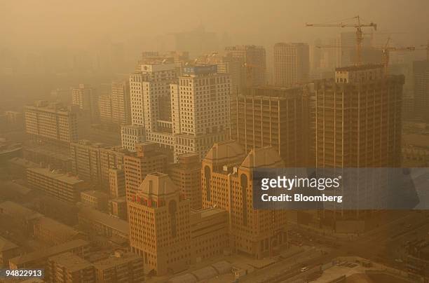 The Guomao neighborhood stands in the midst of pollution seen in the late afternoon in Beijing, China, on Jan. 10, 2006. Beijing is facing a mounting...