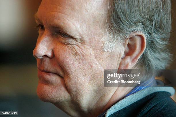 Charles Plosser, president of the Federal Reserve Bank of Philadelphia, talks to a guest during the Federal Reserve Bank of Kansas City annual...