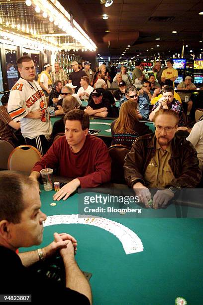 Dealer, foreground in black shirt, waits to begin his first shuffle as the clock ticks down toward the start of the World Series of Poker at Binion's...