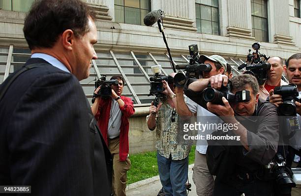 Lawrence "Larry" Stewart, chief forensic scientist for the U.S. Secret Service, runs a gauntlet of news photographers and television cameramen as he...