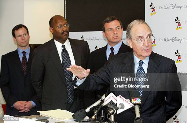 Walt Disney Company Chairman George Mitchell, right, speaks to reporters after a meeting with officials from seven pension funds to discuss Disney's...