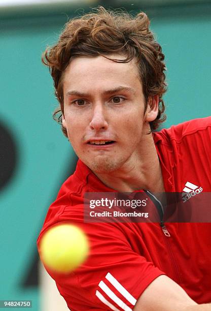 Ernests Gulbis of Latvia keeps his eyes on the ball while playing Novak Djokovic of Serbia during their quarter final match at the French Open in...