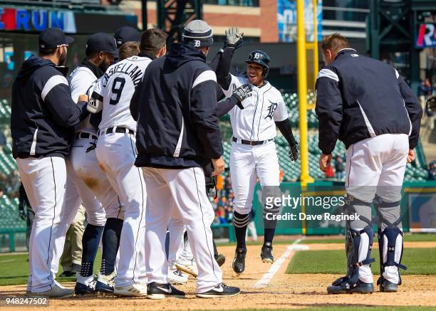 Dixon Machado of the Detroit Tigers hits a walk off home run in the ninth inning against the Baltimore Orioles and celebrates with teammates at home...