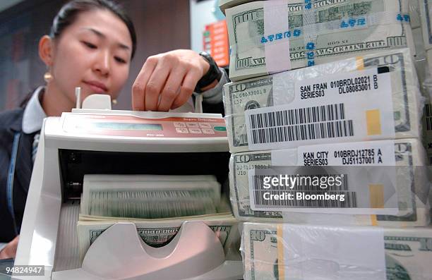 Korea Exchange Bank clerk counts U.S. Hundred dollar bills at the bank's headquarters in Seoul, South Korea Friday, January 6, 2006. Hana Financial...