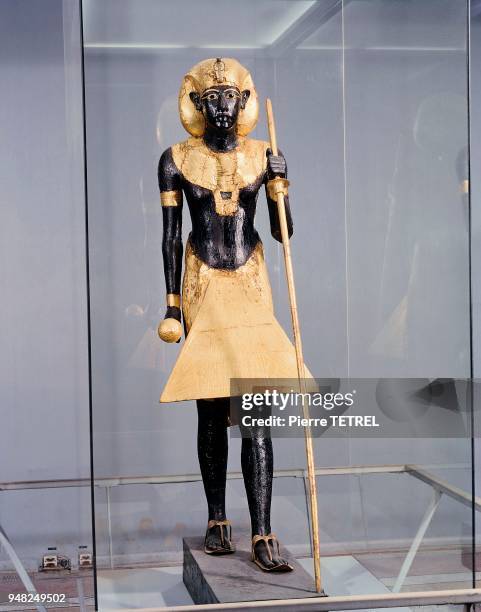 Statue en bois rouge bitumée et dorée avec plâtre, bronze doré et pâte de verre, à l'effigie du Pharaon mais représentant HARAKHTY, un des aspects...